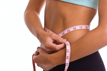 Weight loss tips. Female with tape measure